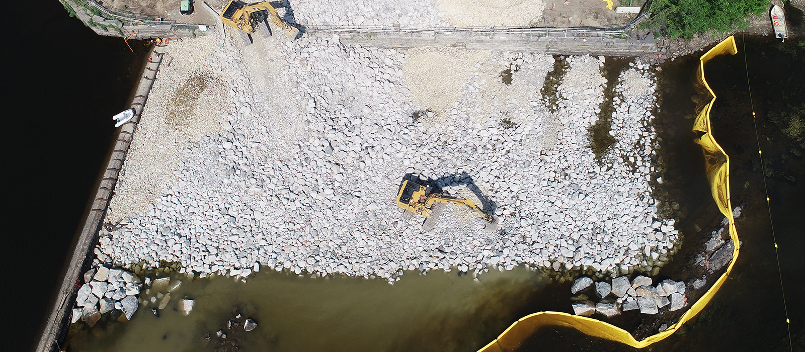 Aerial View Of Excavator Lifting And Moving Large Rocks At Saco Fishway