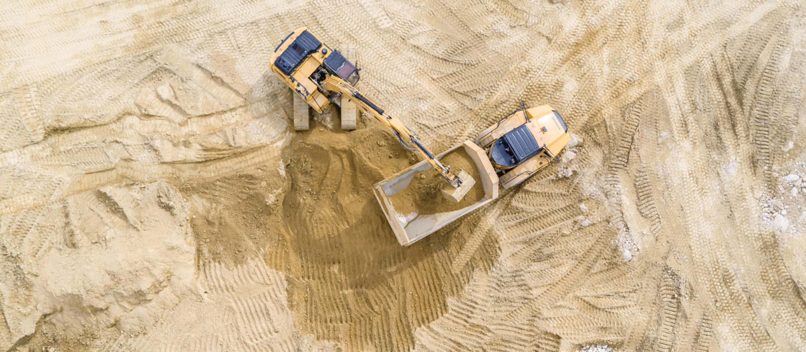 Aerial View Showing Sargent's Large Equipment's Moving Fine Grading Using Large Excavator and Dump Truck