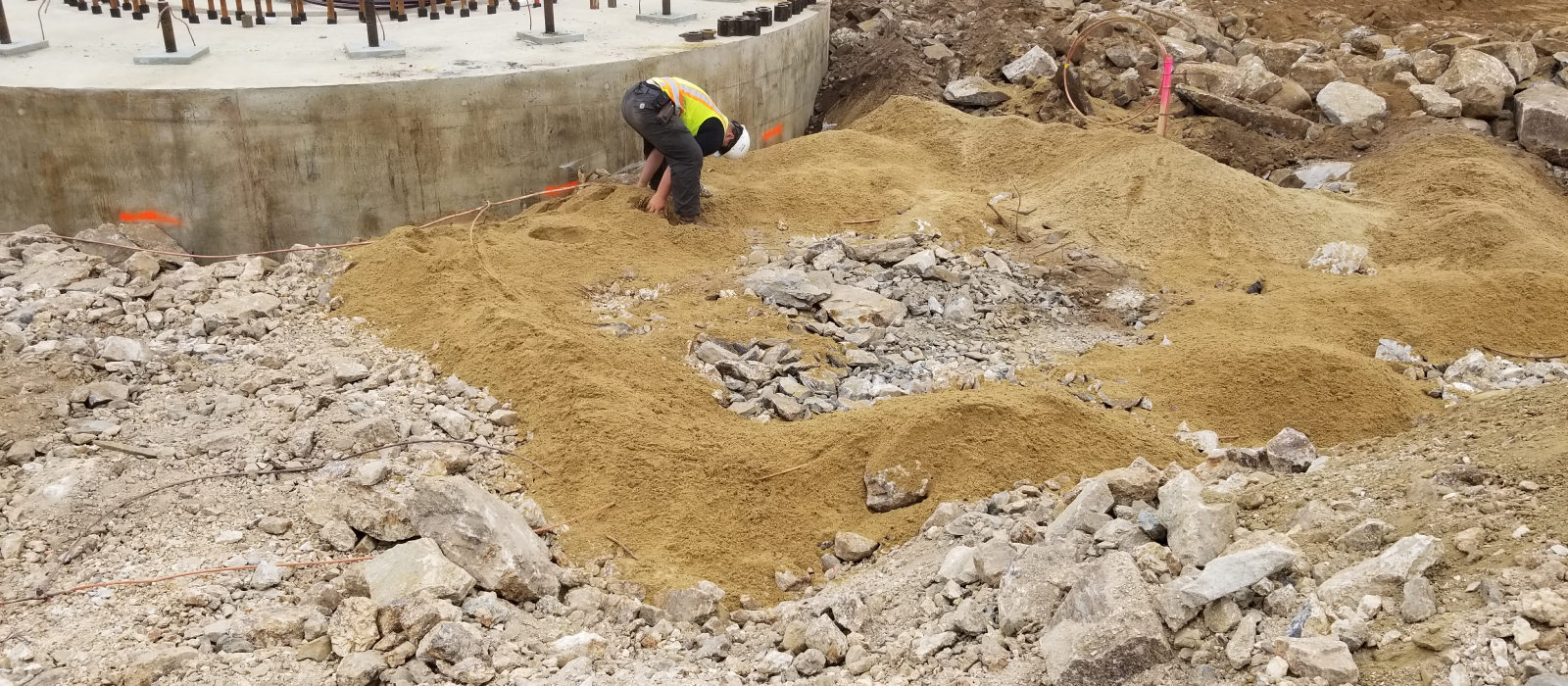 One Of Crew Aligning Concrete Pipe Lines At Wind Farm Sitework