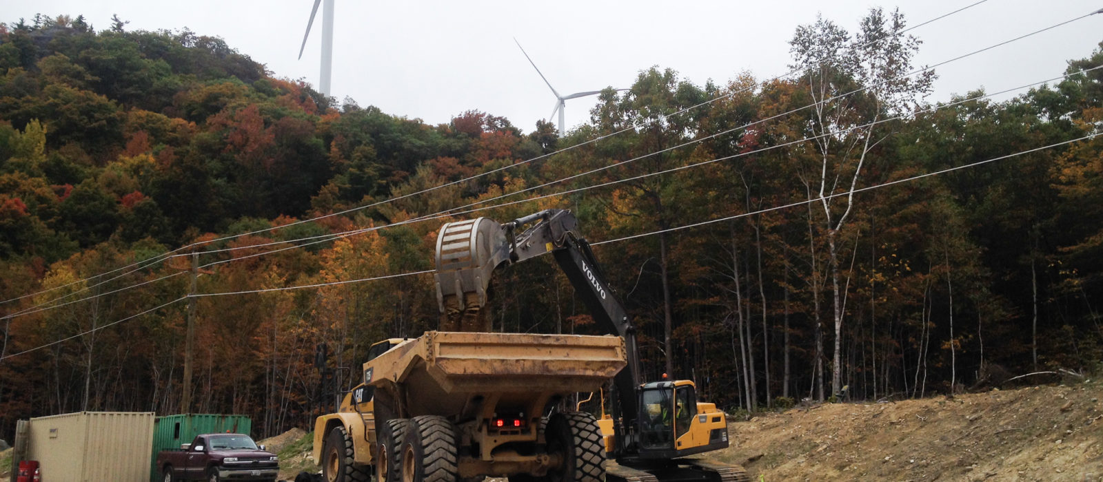 Large Excavator With Claw Dropping Fine Soil To Dump Truck