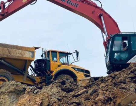 Small Size Excavator Dropping Dirt Soil To Medium Size Dumptruck